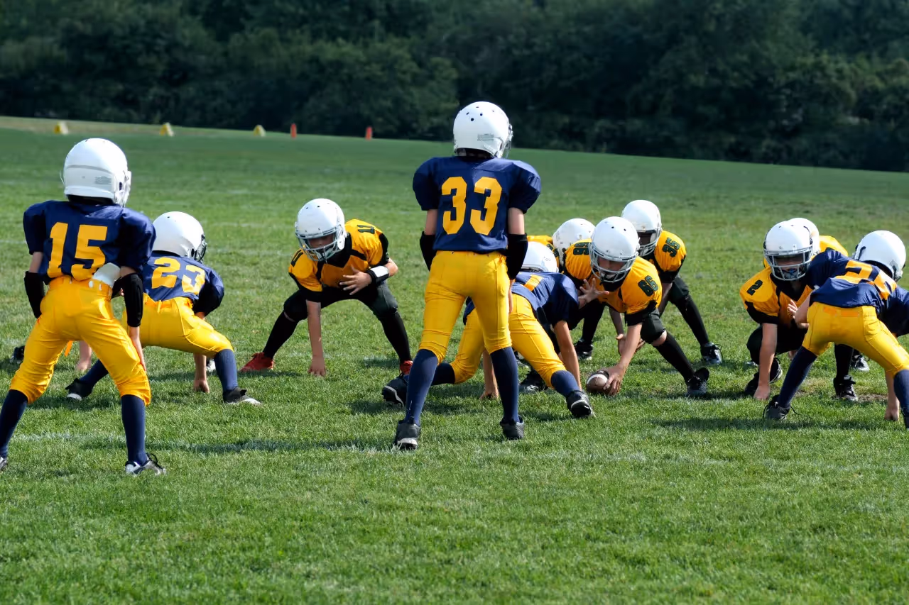 Children playing American football.