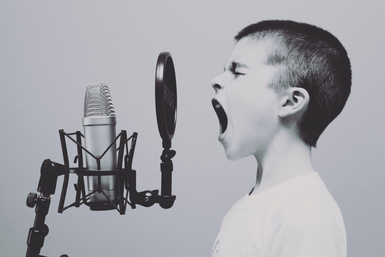 Child singing into a microphone
