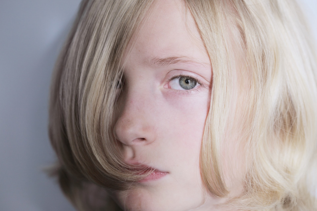 a blonde-haired child looking upset