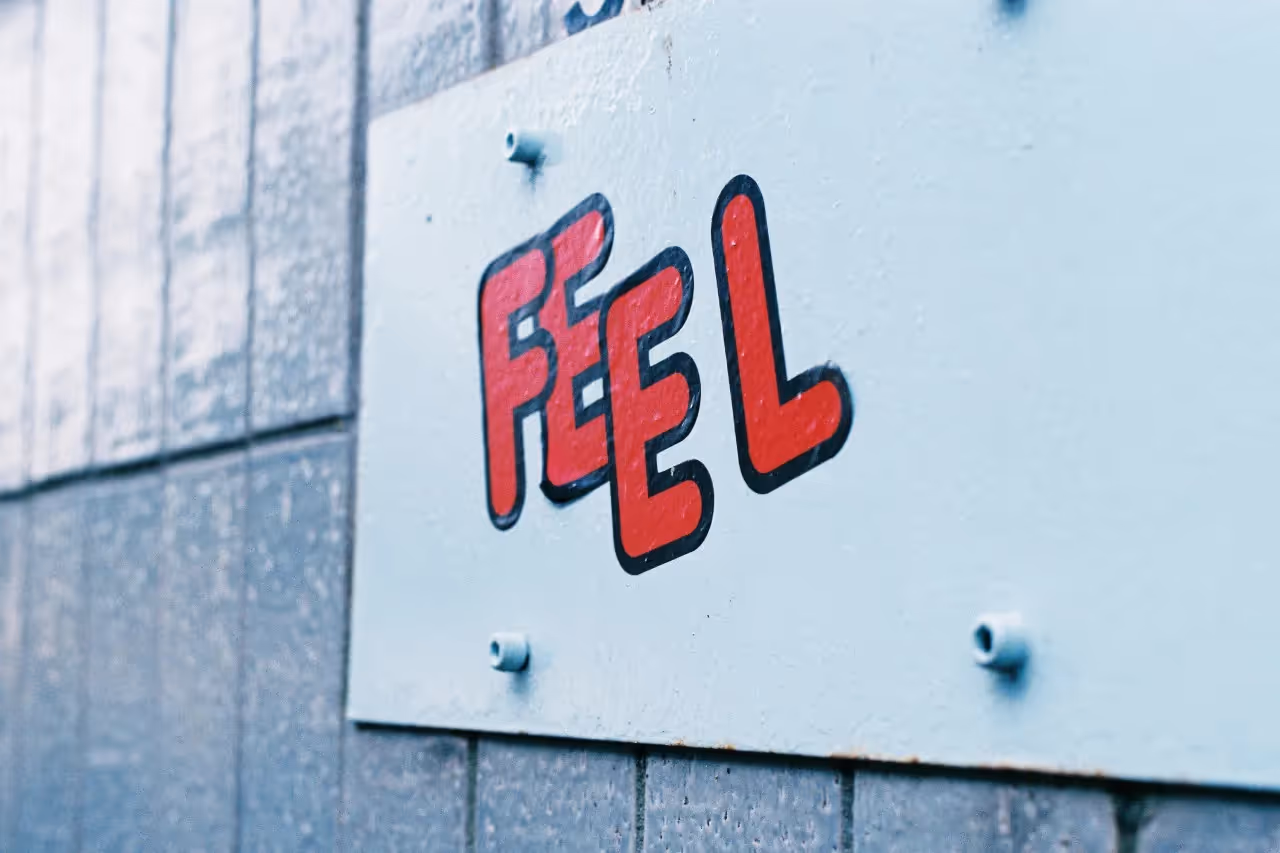 Stickers on a wall that say Feel