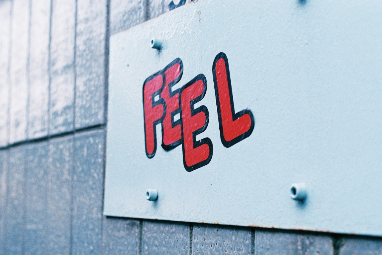 Stickers on a wall that say Feel