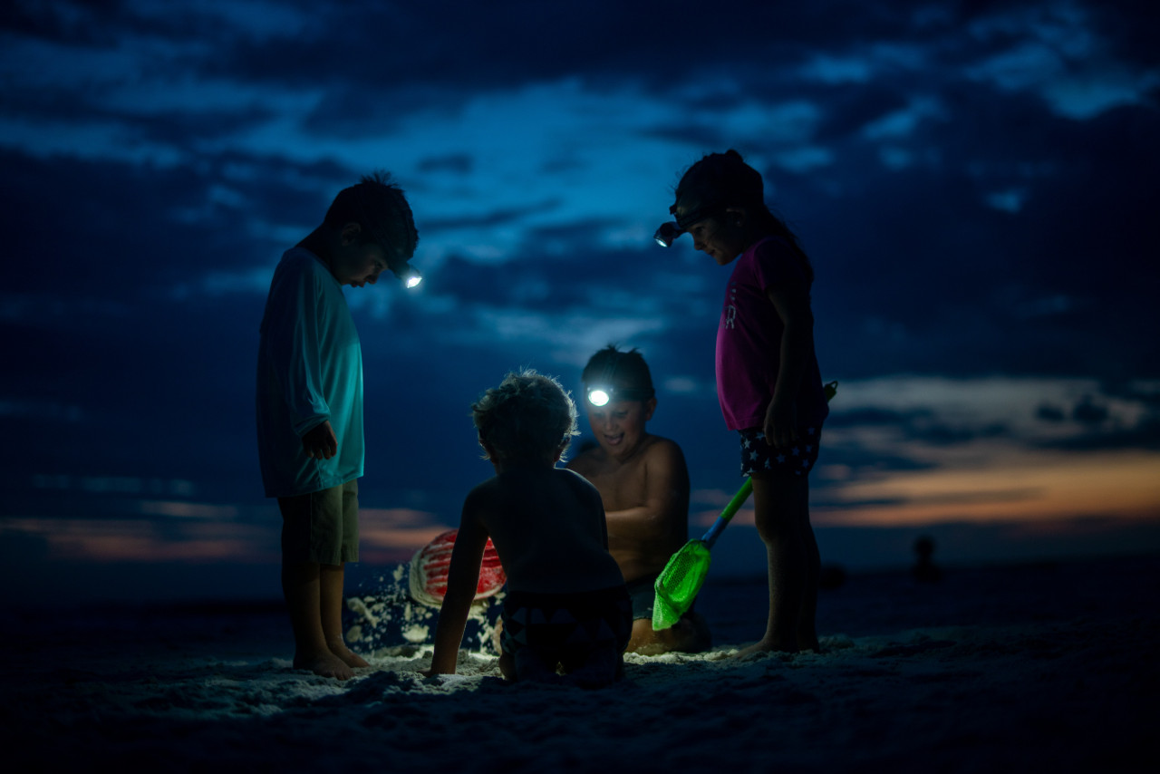 A group of young friends playing at night.