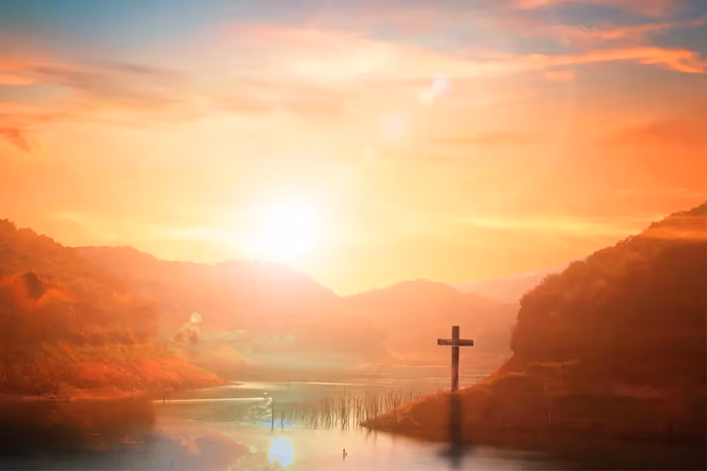 View of the water with a cross on land.