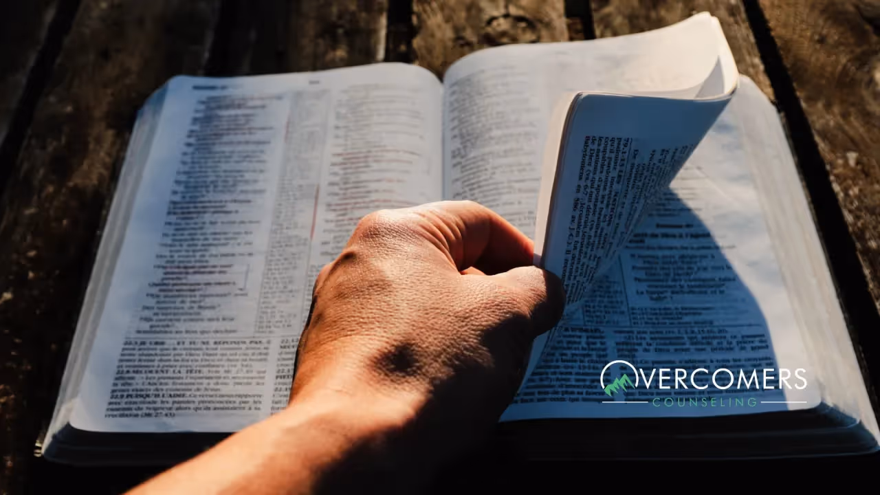 a person turning pages on a bible
