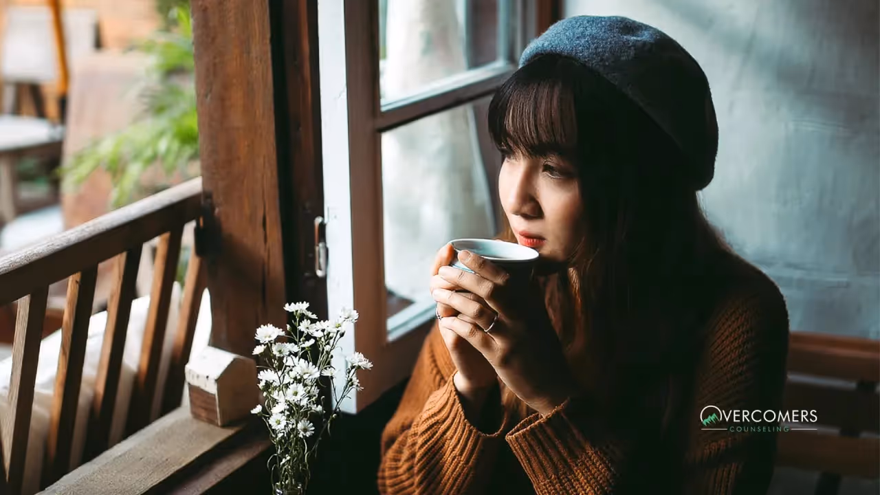 a person looking relaxed and drinking coffee