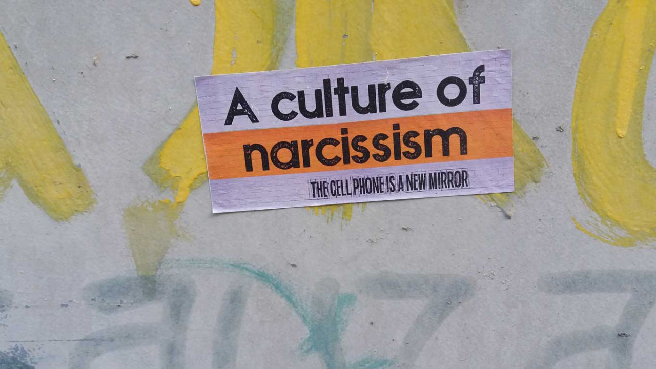 a sticker on a wall that says a culture of narcissism