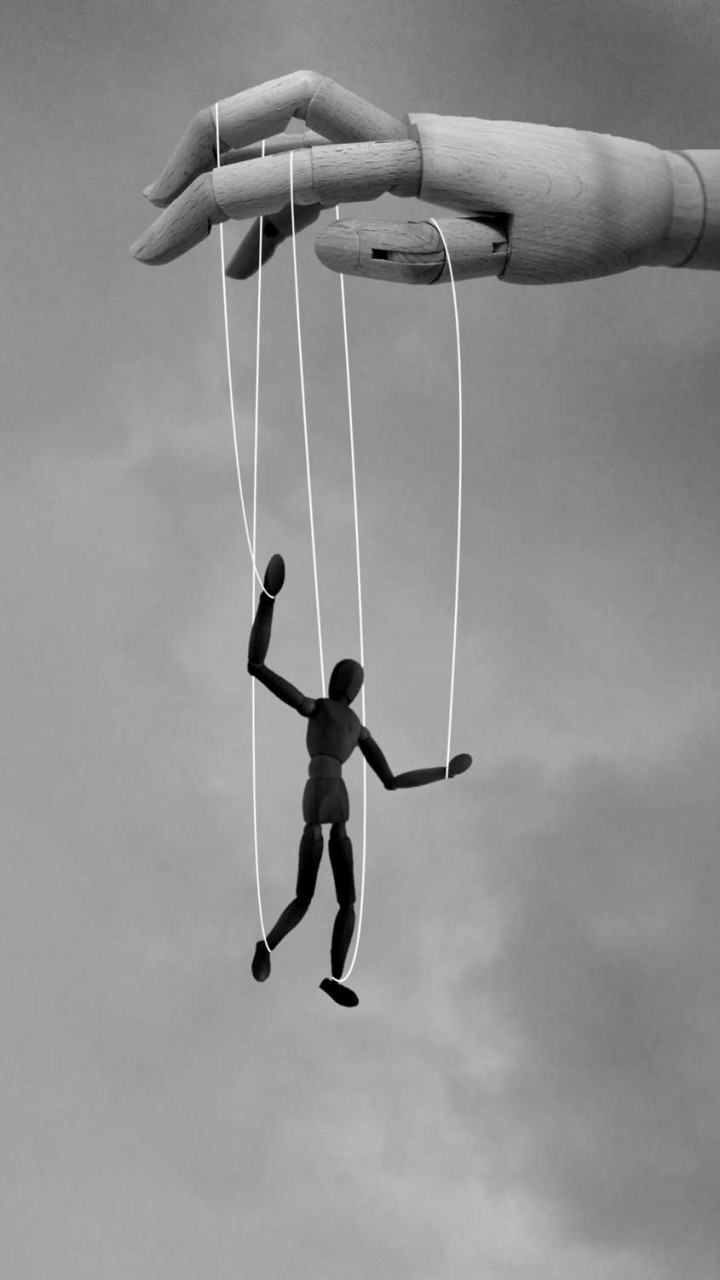 a marionette with a hand holding it