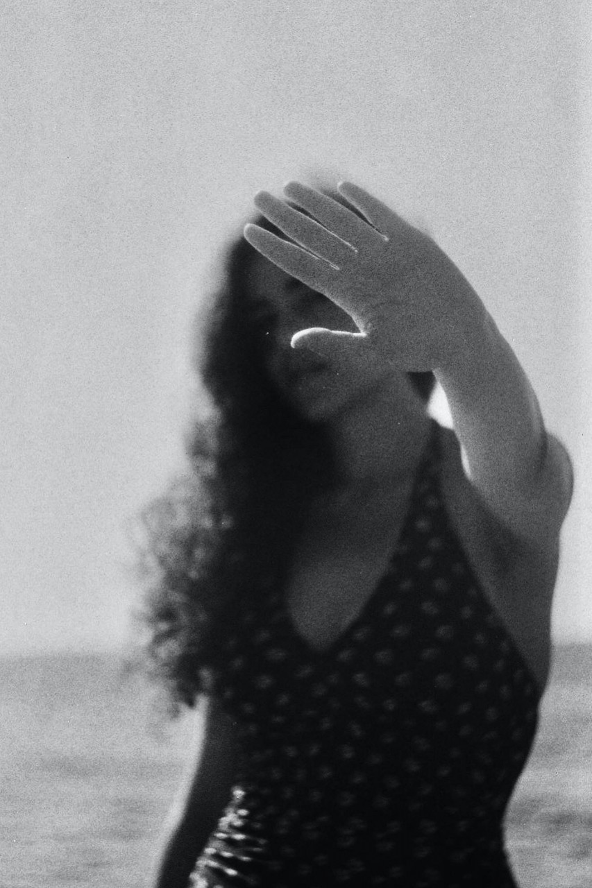 Woman holding her hand up out in front of her