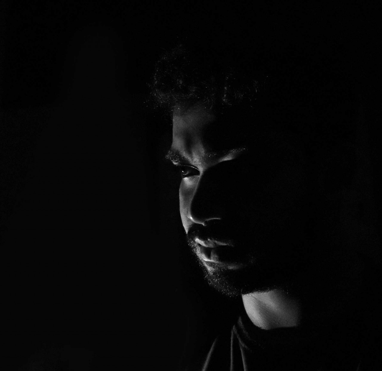 a young man with an intimidating look on his face