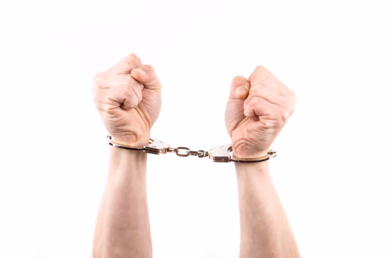 Arms in the air while handcuffed