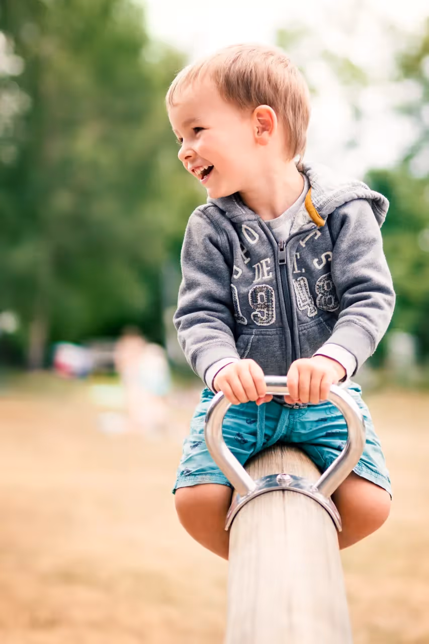 A child playing on a beam.