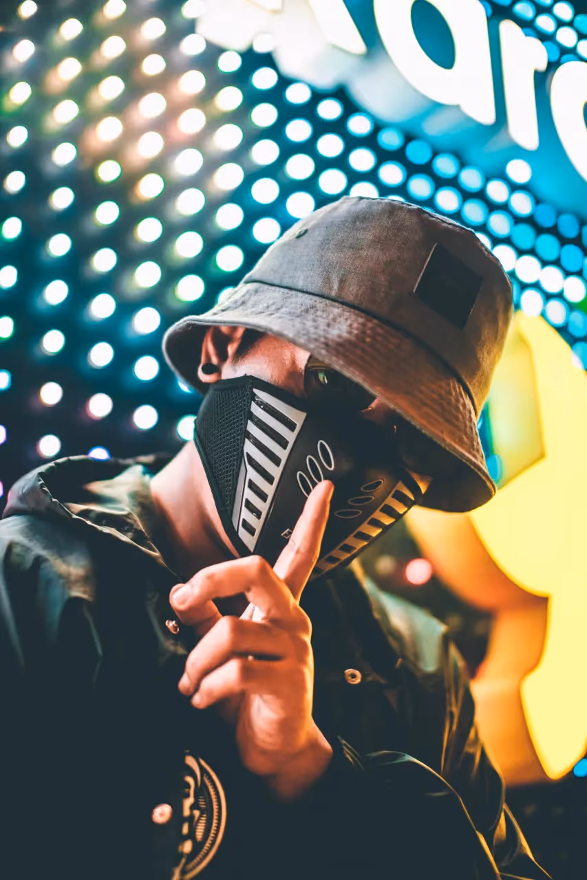 A man doing a shutup sign.