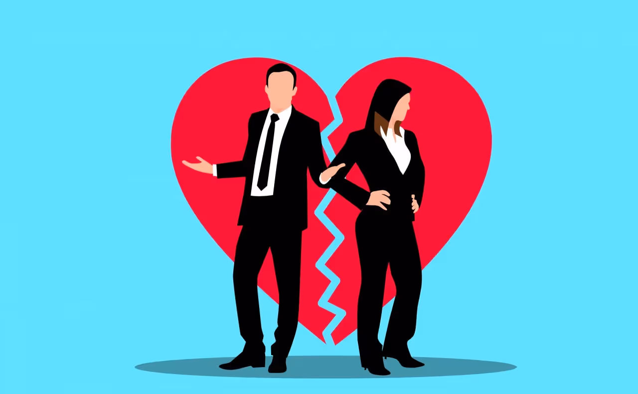 A man and a woman standing on opposite sides of a broken heart.