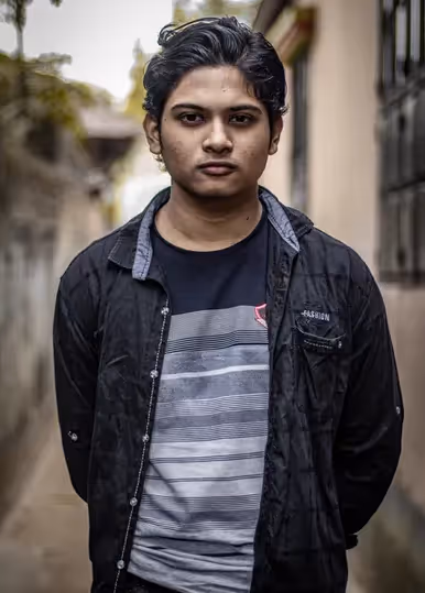 A man standing with his hands behind his back.