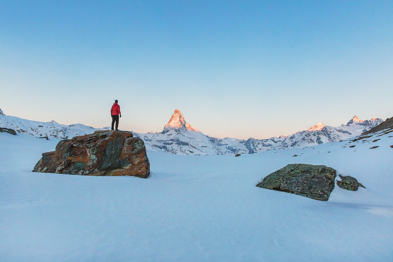 A victim standing alone in a desolate landscape.