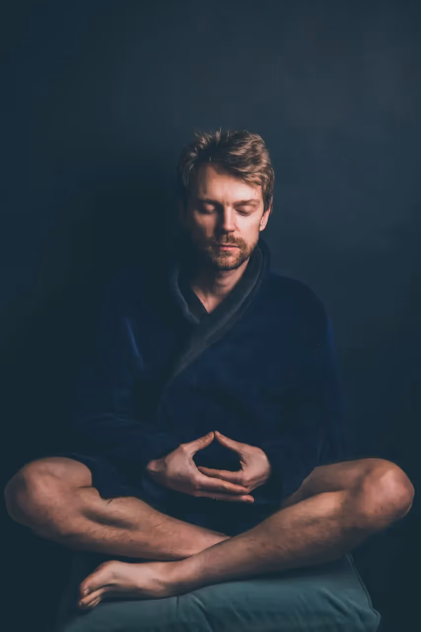 A man meditating to control his emotions.