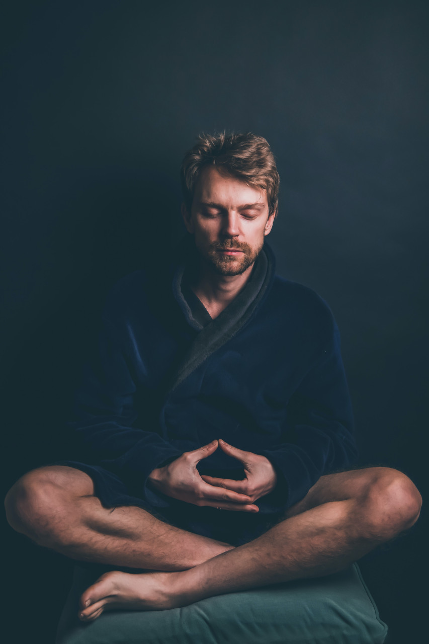 A man meditating to control his emotions.