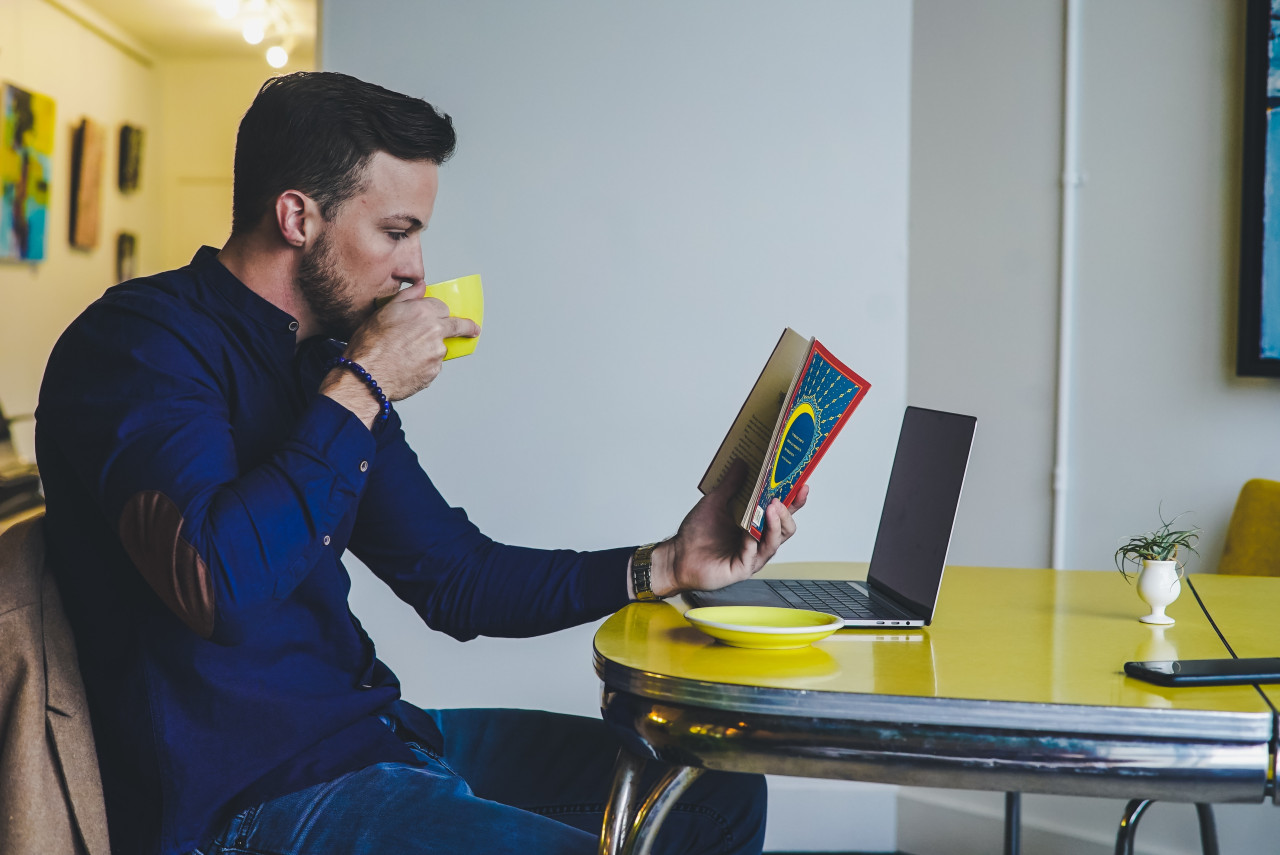 A man reading about NPD from a book.