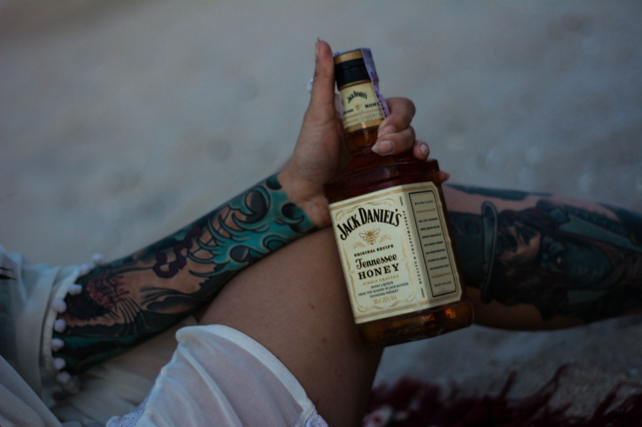 A man self-sabotaging with alcohol.