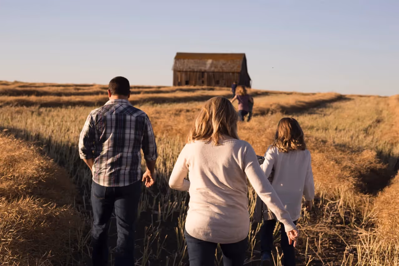 Parents and their kids walking in a farm.