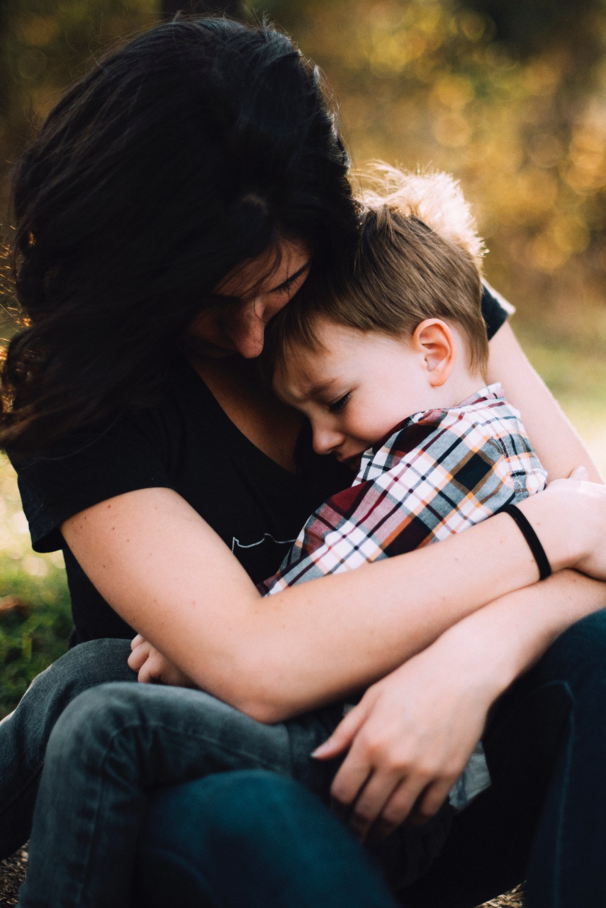 A mother consoling her crying child.