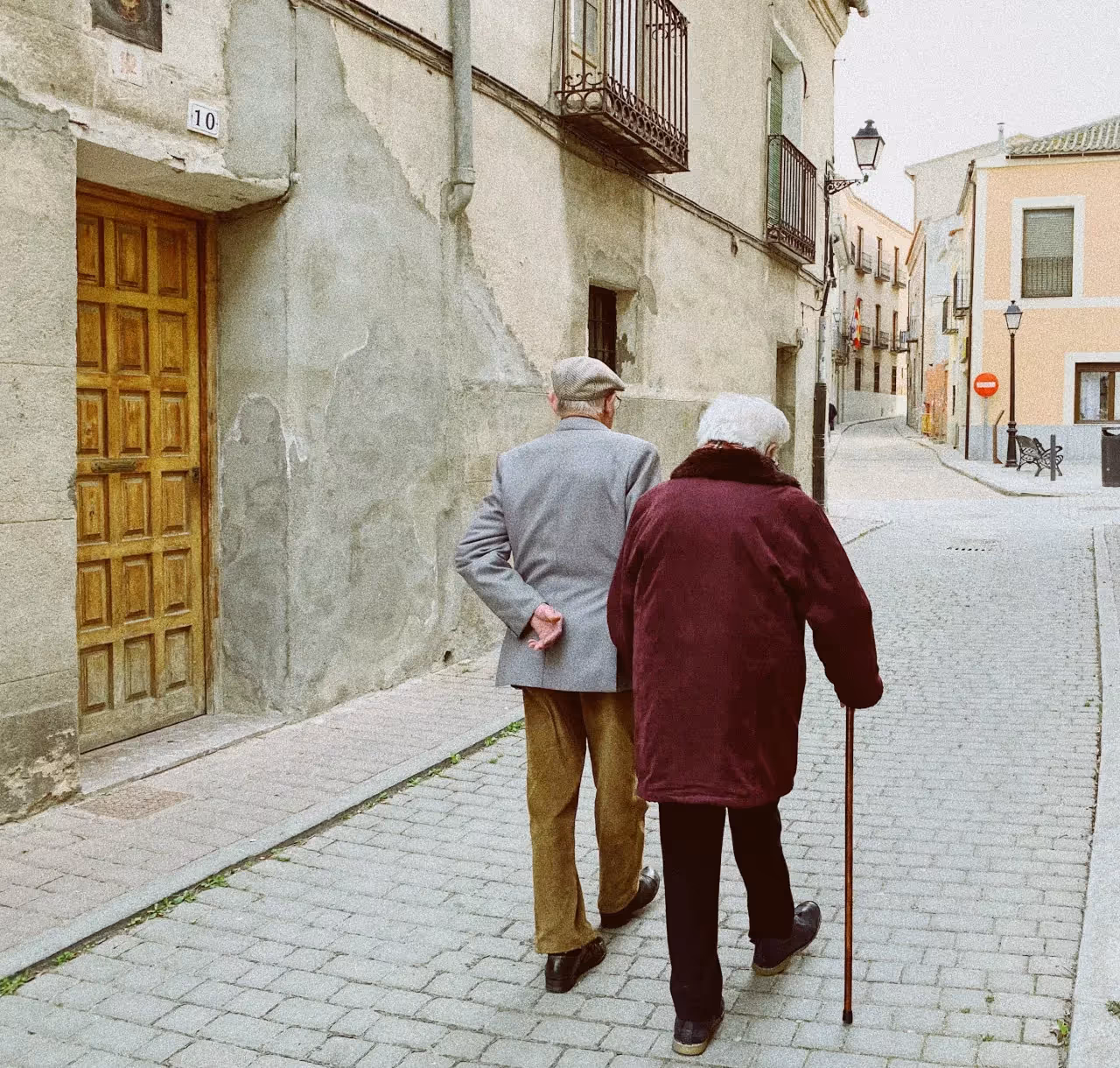 Old parents walking down a road.