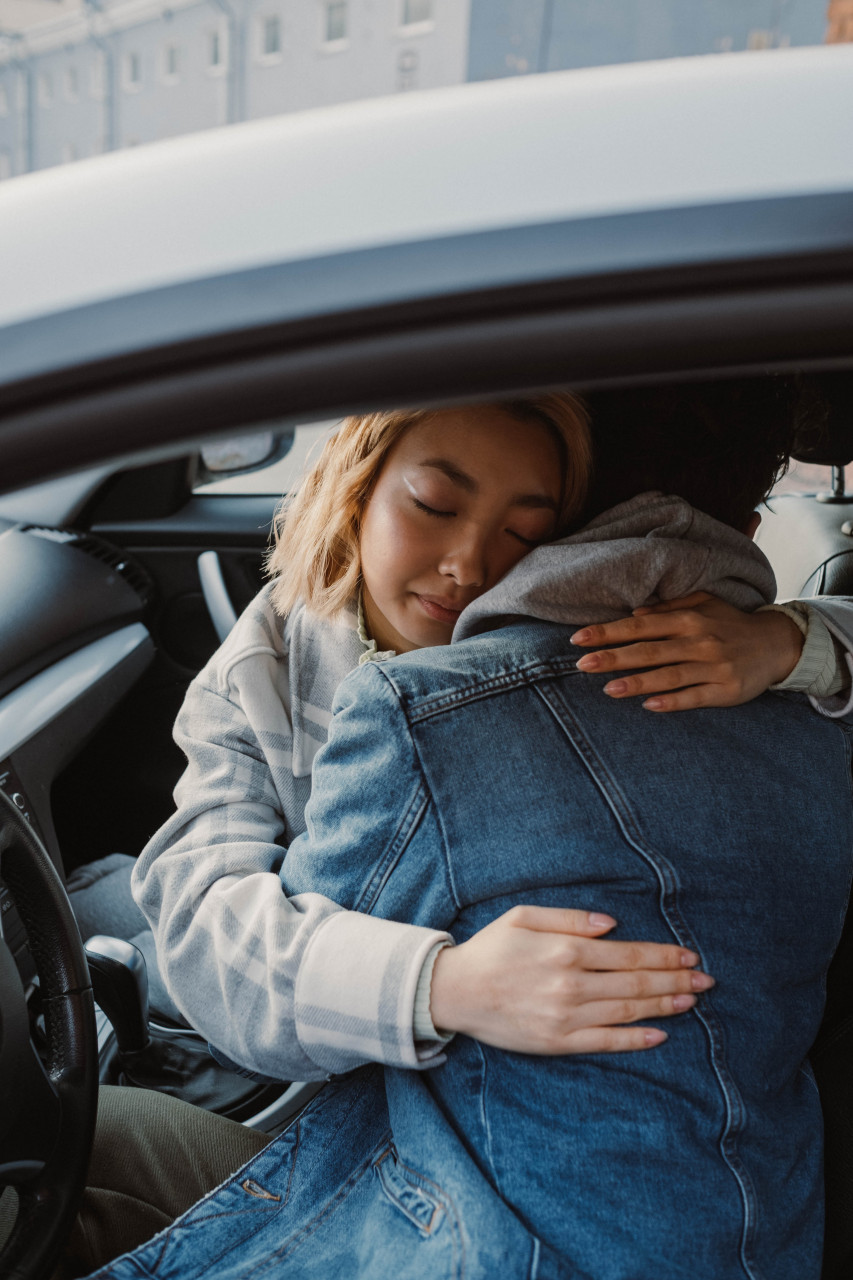 A couple embracing in the car.