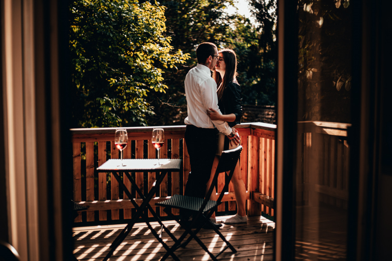 Husband and wife hugging in the porch.