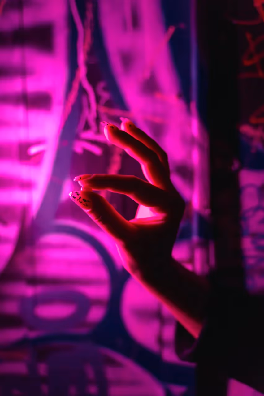 A person holding up a pill.