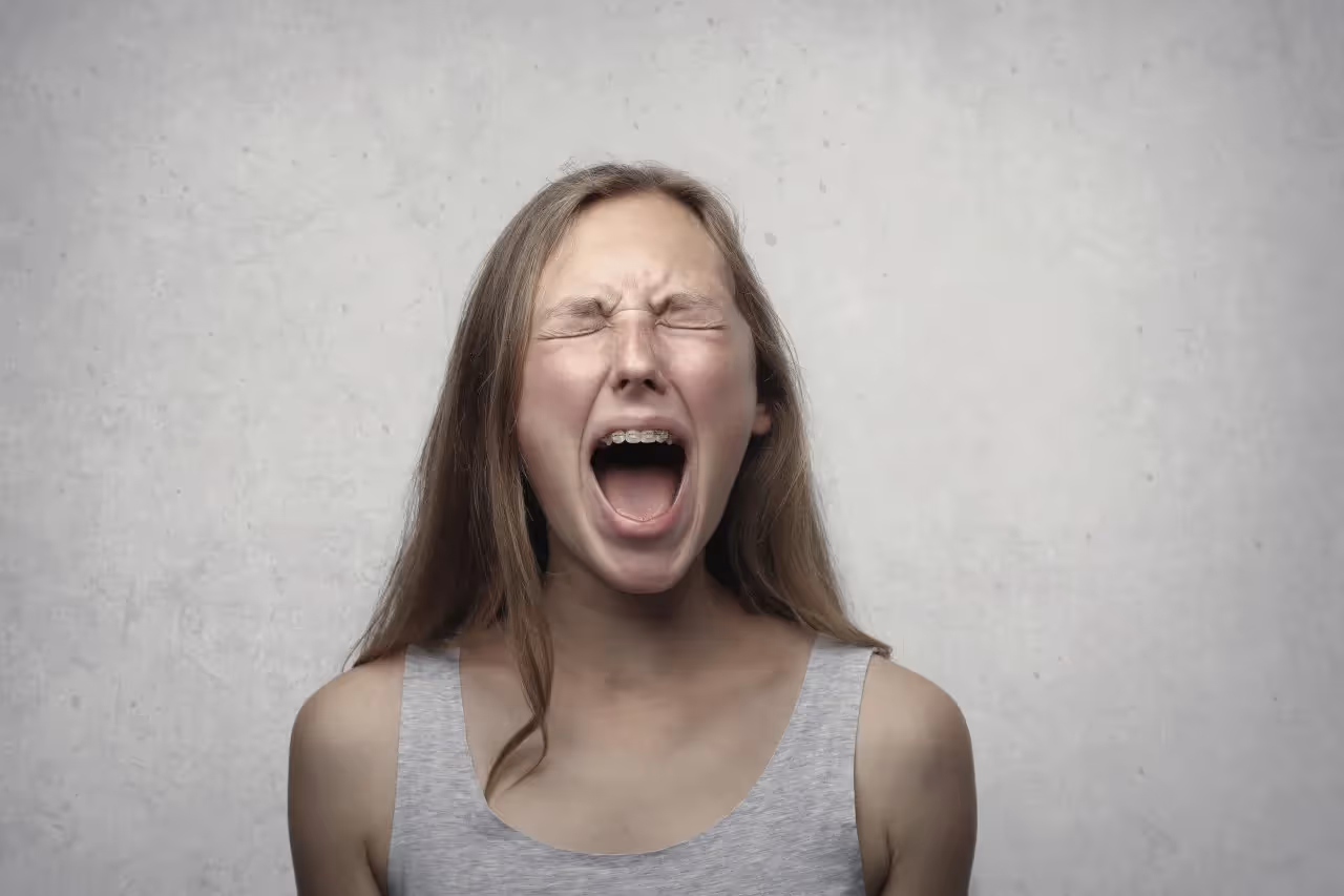 A lady screaming in anger.