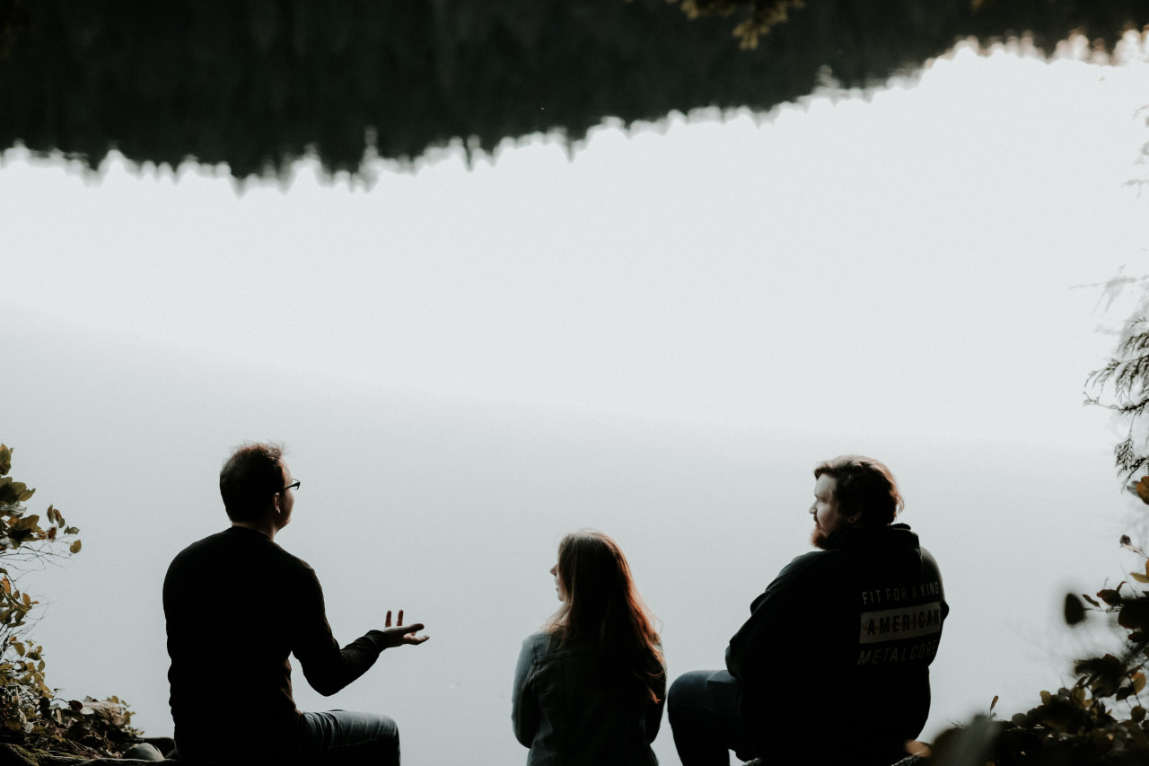 A man talking to other people.
