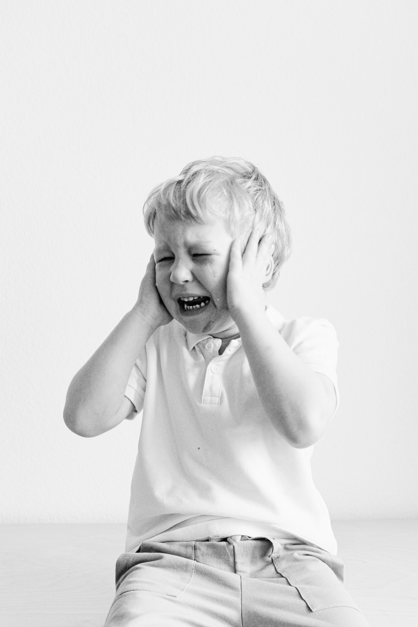 A boy screaming in emotional pain.