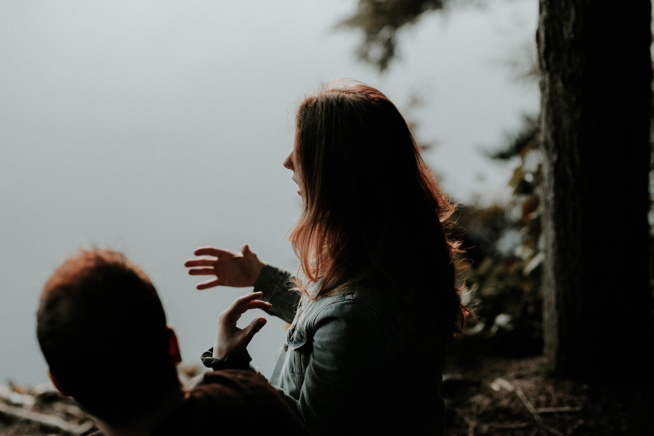 A lady talking to a man.