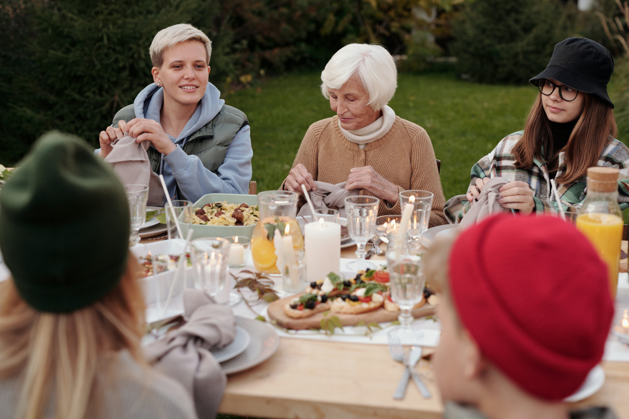 A group of adults having a picnic.