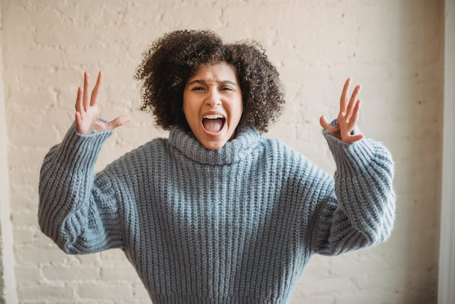 woman in a sweater angry.