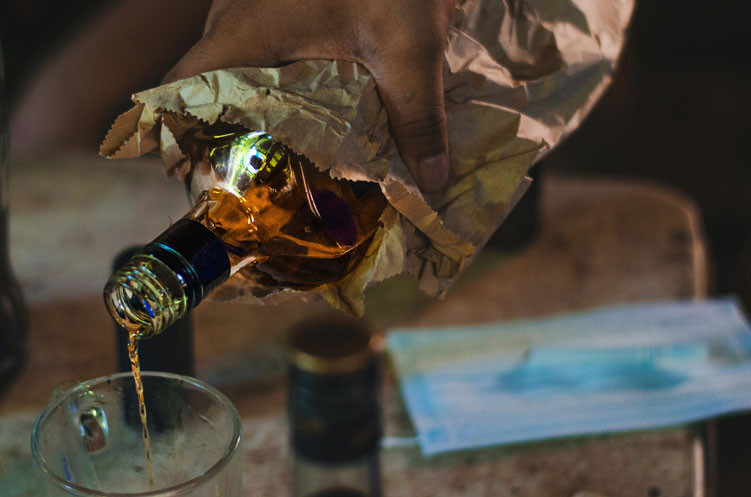 alcohol being poured into a cup