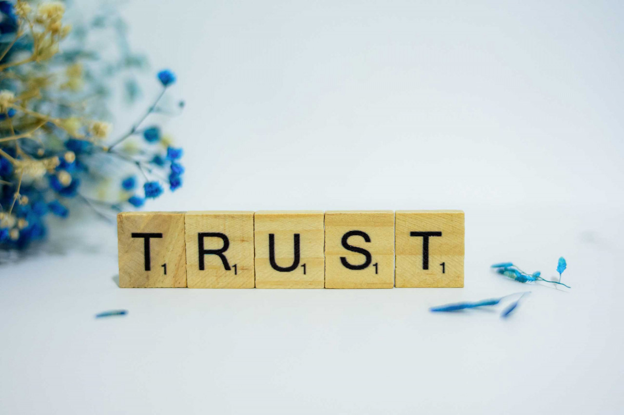scrabble tiles spelling the word trust