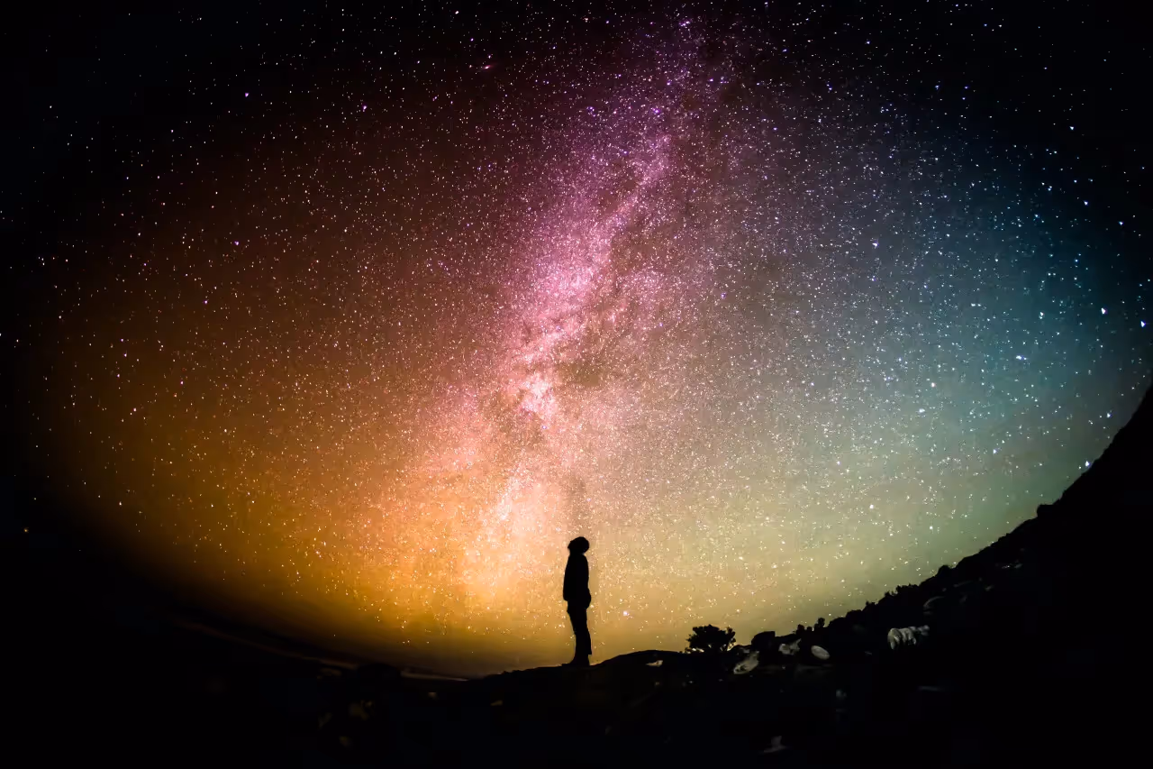 Person standing outside looking at the stars