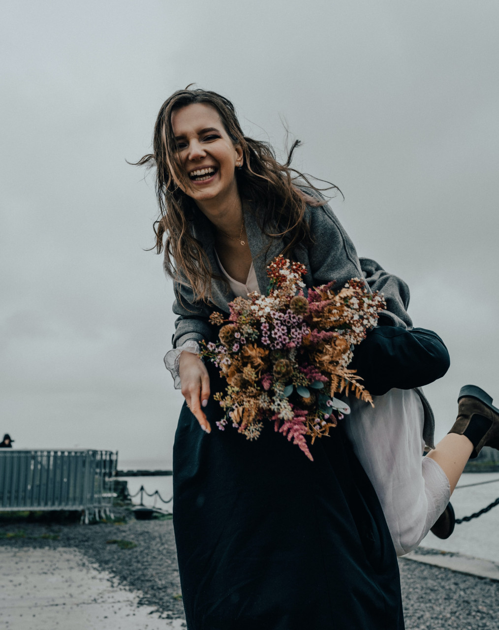 a woman smiling and being lifted up
