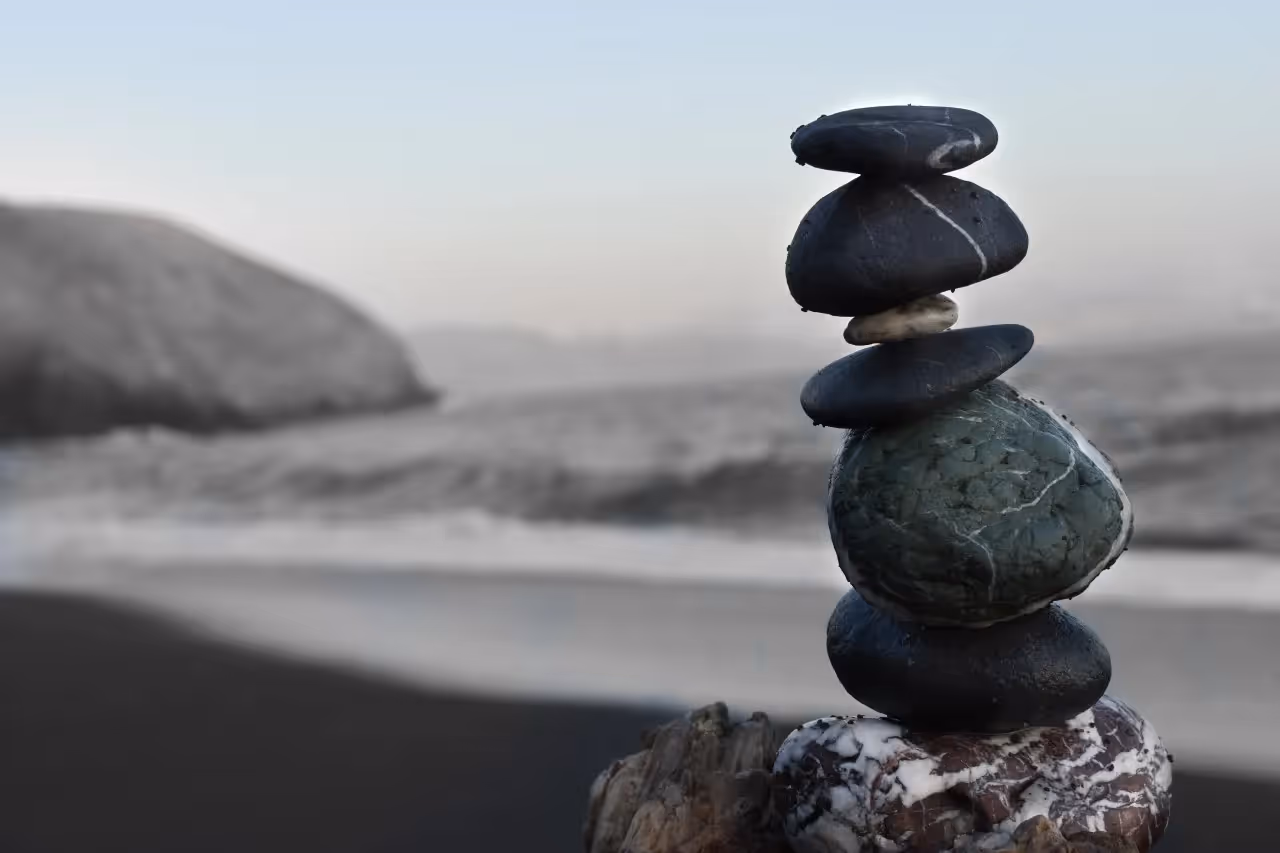 Stacked rocks by a body of water