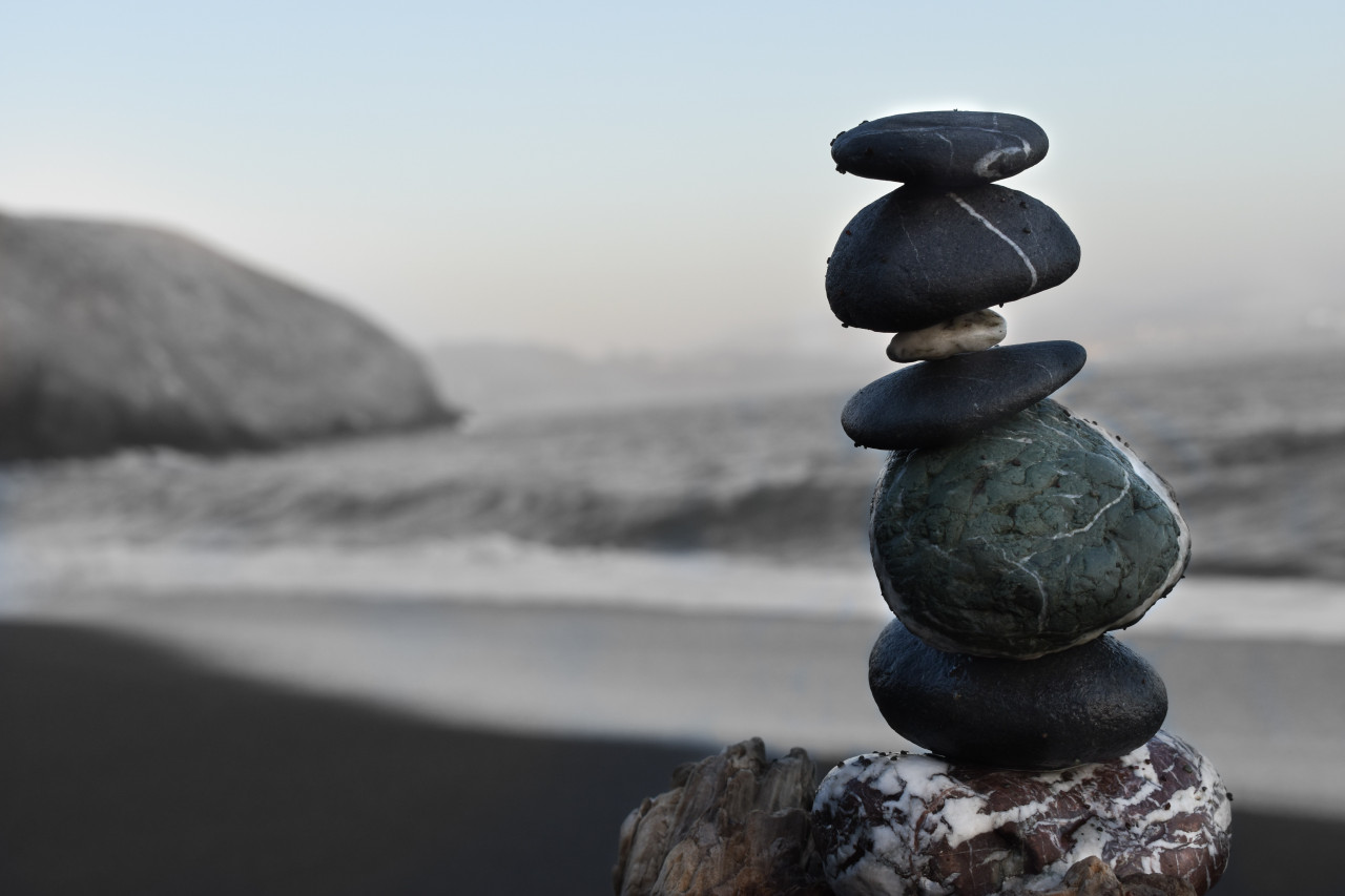 Stacked rocks by a body of water