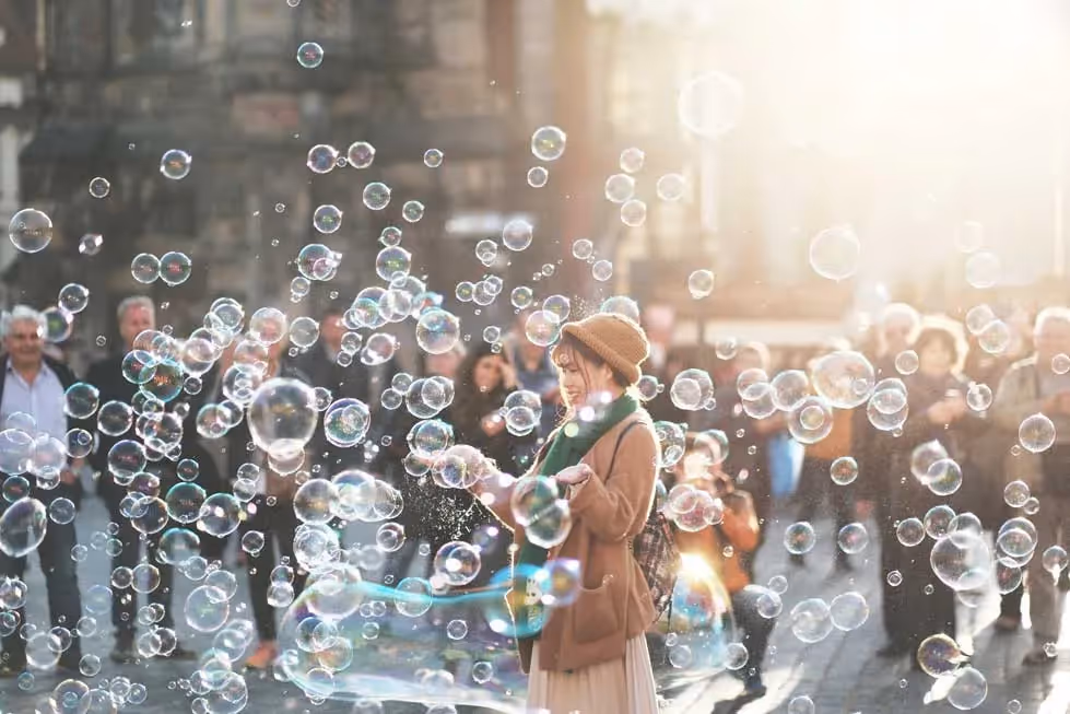 a person enjoying a bunch of bubbles floating around them