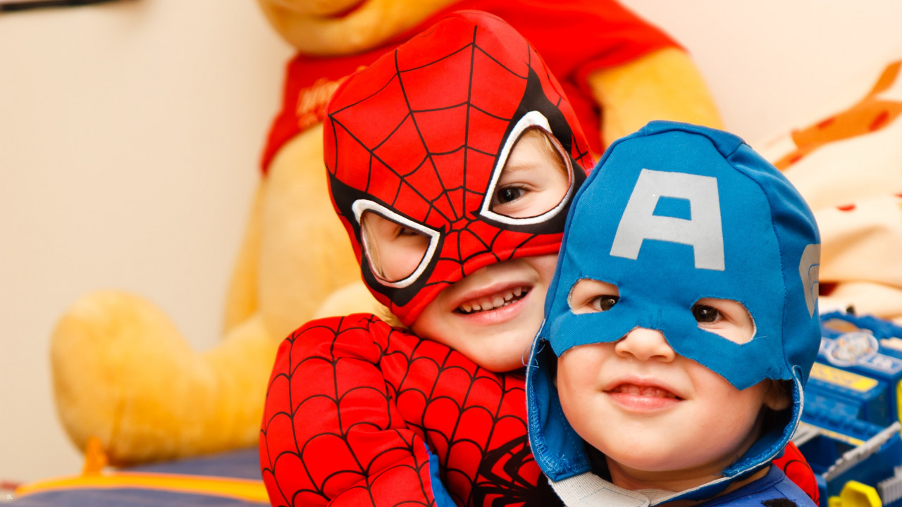 Two kids dressed up as Spiderman and Captain America.
