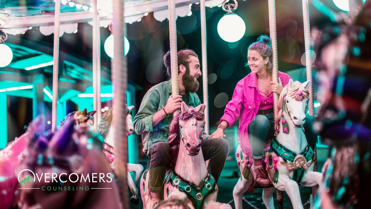a couple on a date riding a carousal together
