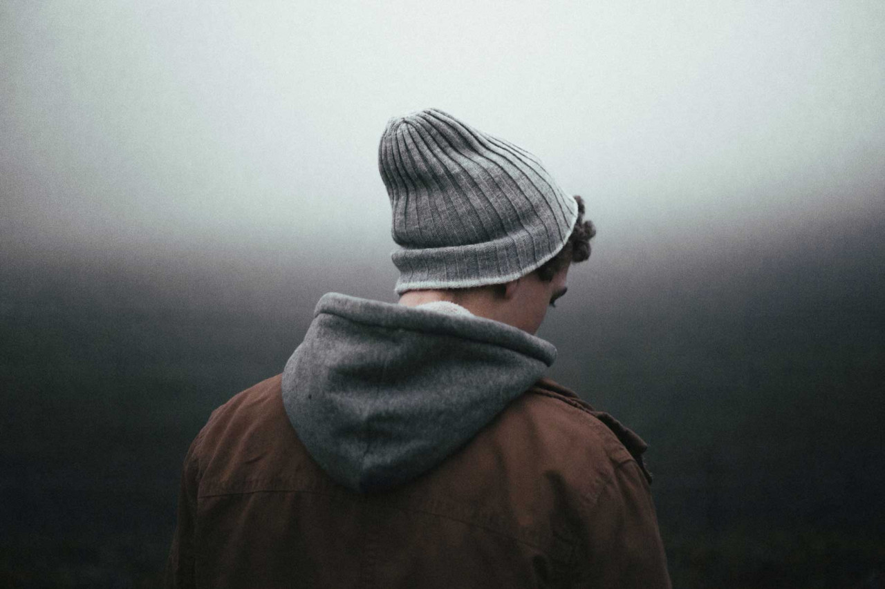 sad teenager looking down