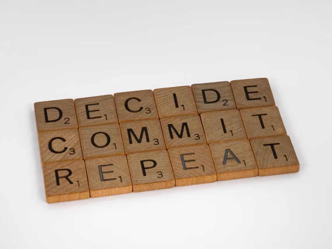 scrabble tiles that say decide commit and repeat