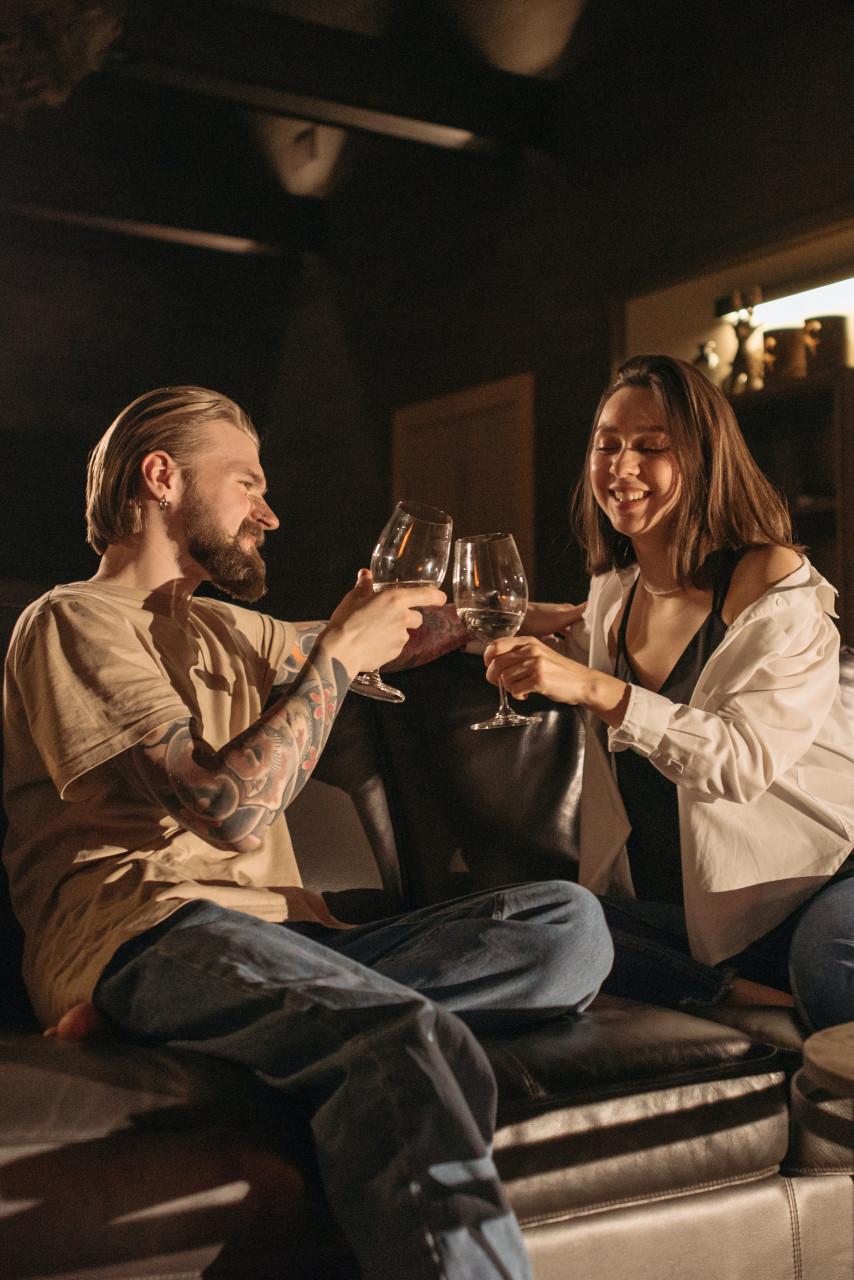 A couple drinking wine together.