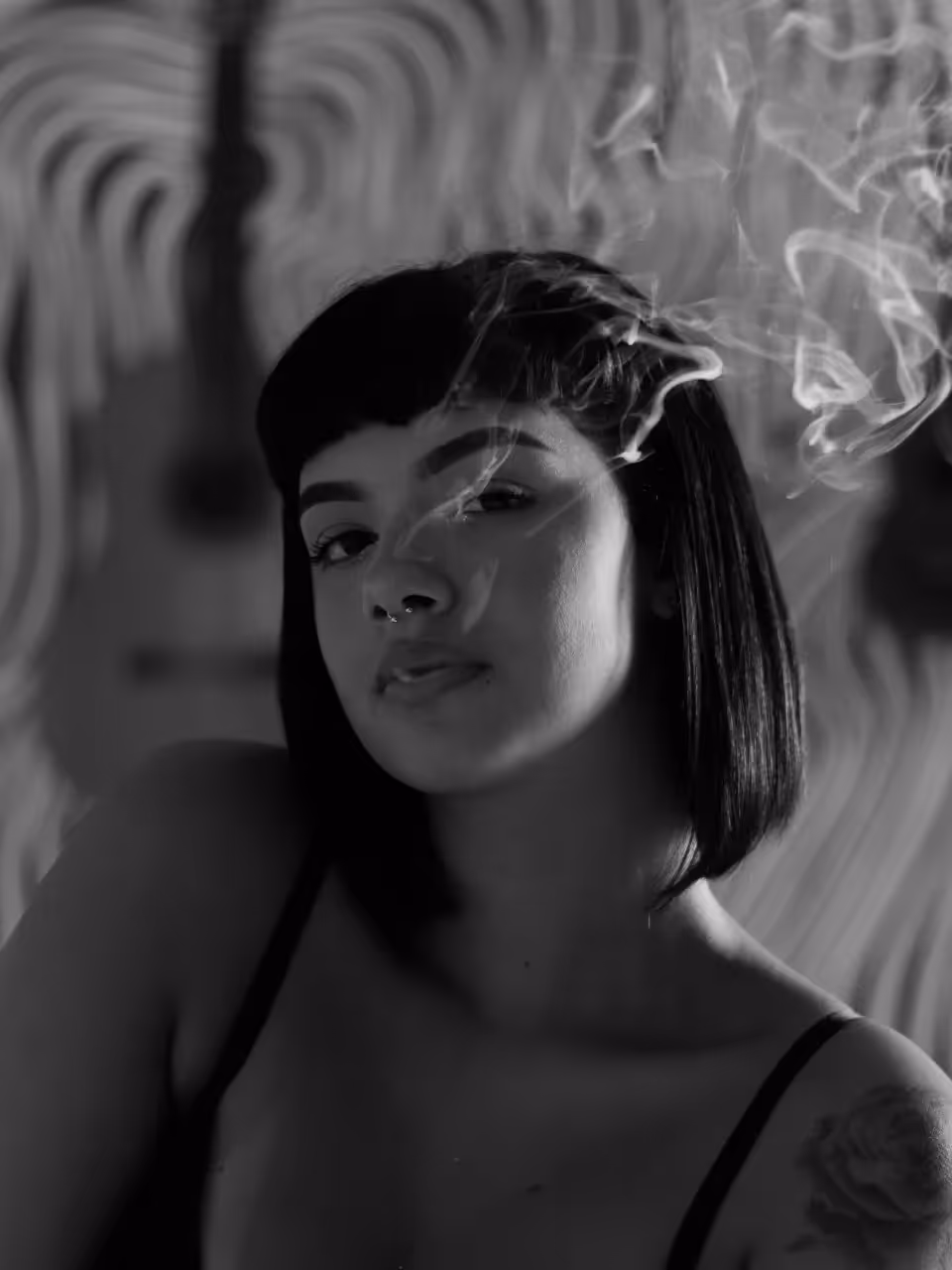 A lady smoking indoors.