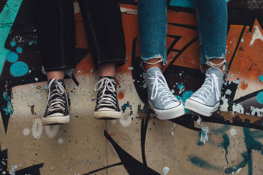 teenagers sitting on a wall