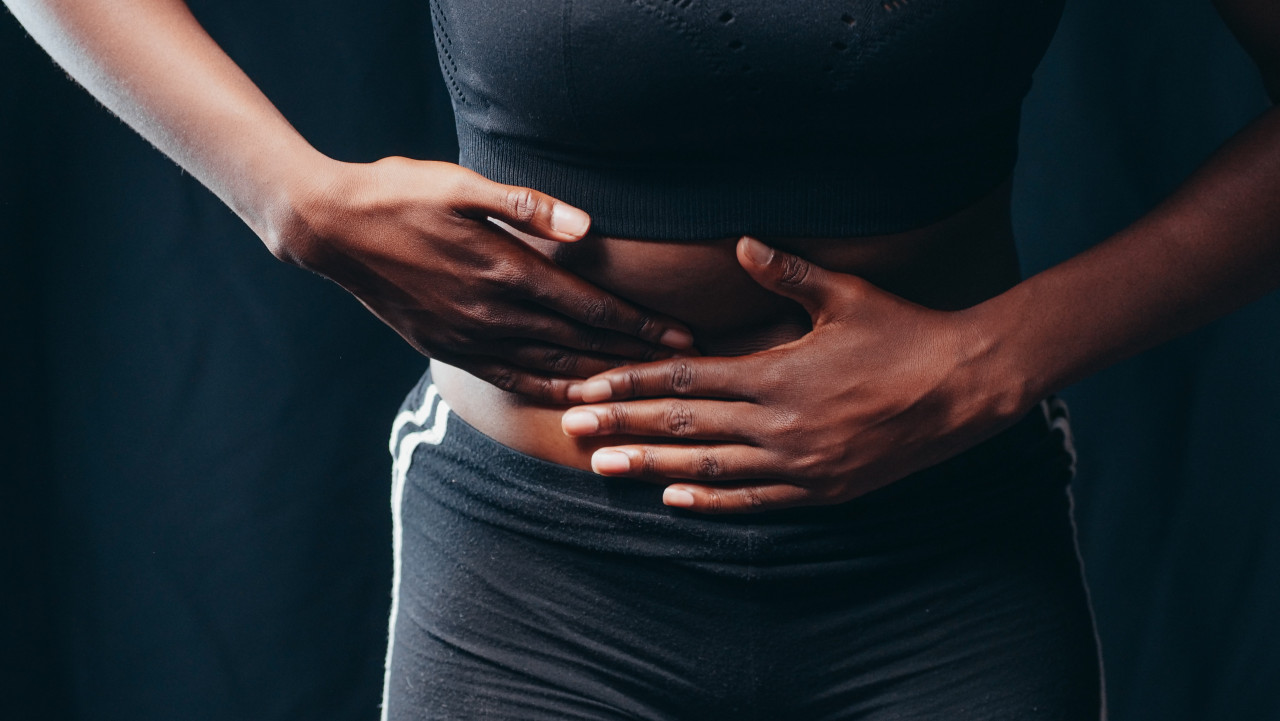 A person feeling some pain in their midsection.